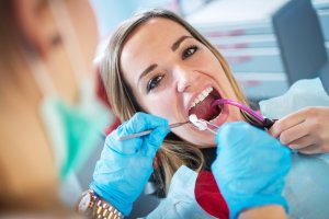 Girl In Dentist Chair Receiving Dental Implants And Crown