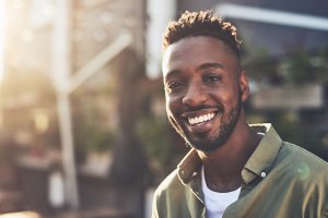 A man smiling with white teeth